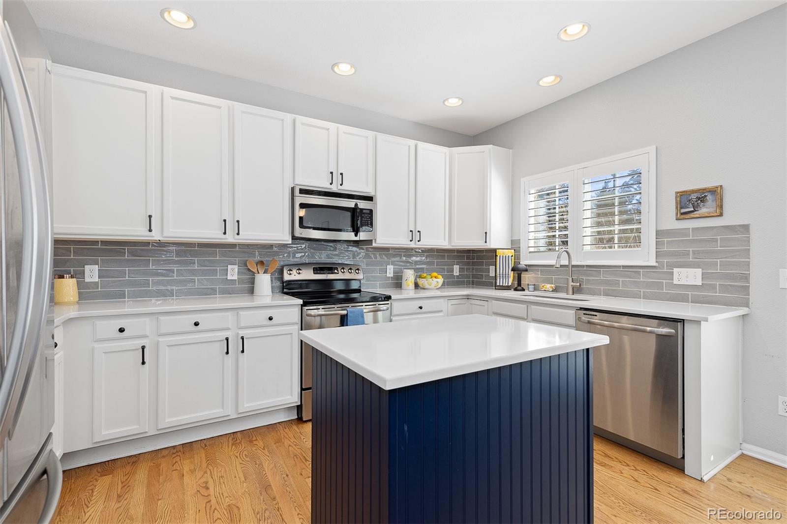 9810 Mulberry Way Highlands Ranch, CO 80129 - Photo 12 of 49 a kitchen with sink cabinets and window
