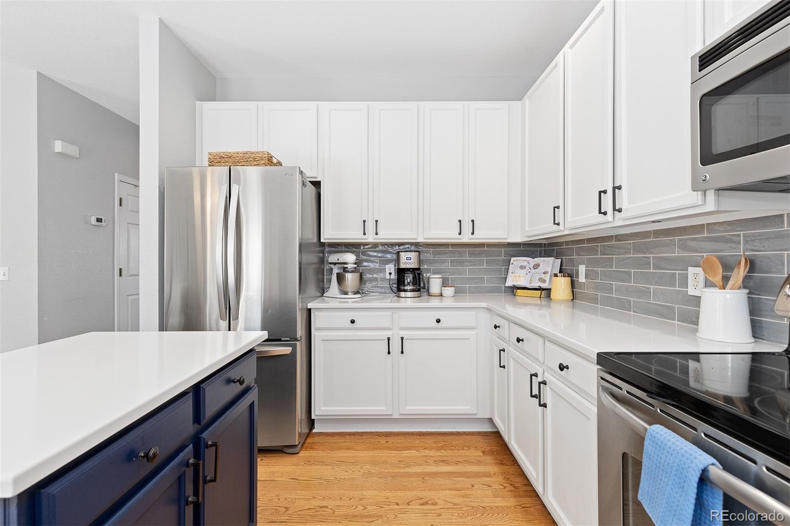 9810 Mulberry Way Highlands Ranch, CO 80129 - Photo 14 of 49 a kitchen with stainless steel appliances a refrigerator sink and cabinets
