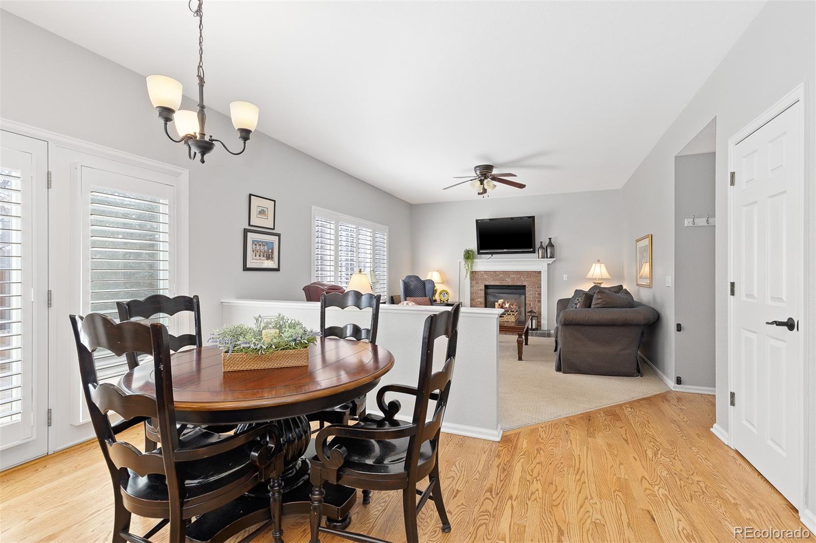 9810 Mulberry Way Highlands Ranch, CO 80129 - Photo 17 of 49 a view of a dining room with furniture window and wooden floor