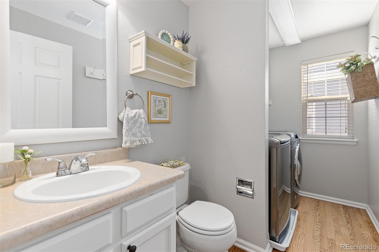 9810 Mulberry Way Highlands Ranch, CO 80129 - Photo 20 of 49 a bathroom with a granite countertop toilet sink and mirror