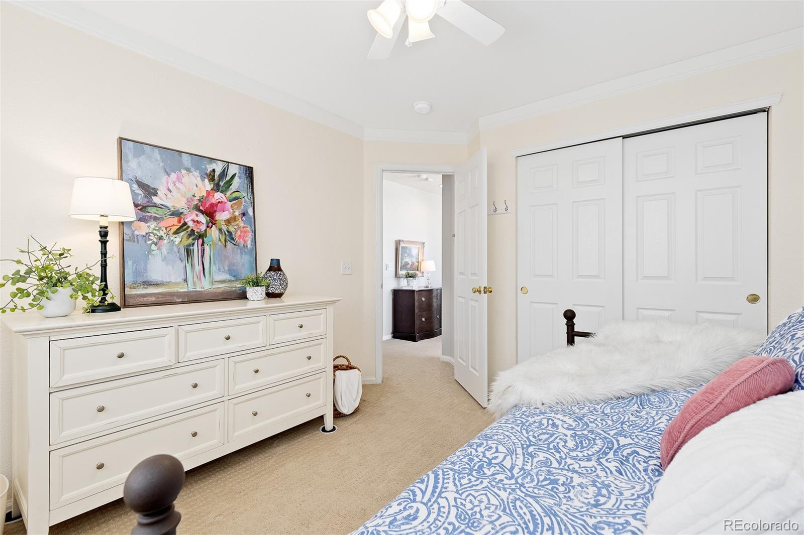 9810 Mulberry Way Highlands Ranch, CO 80129 - Photo 24 of 49 a spacious bedroom with a bed and a mirror on dresser