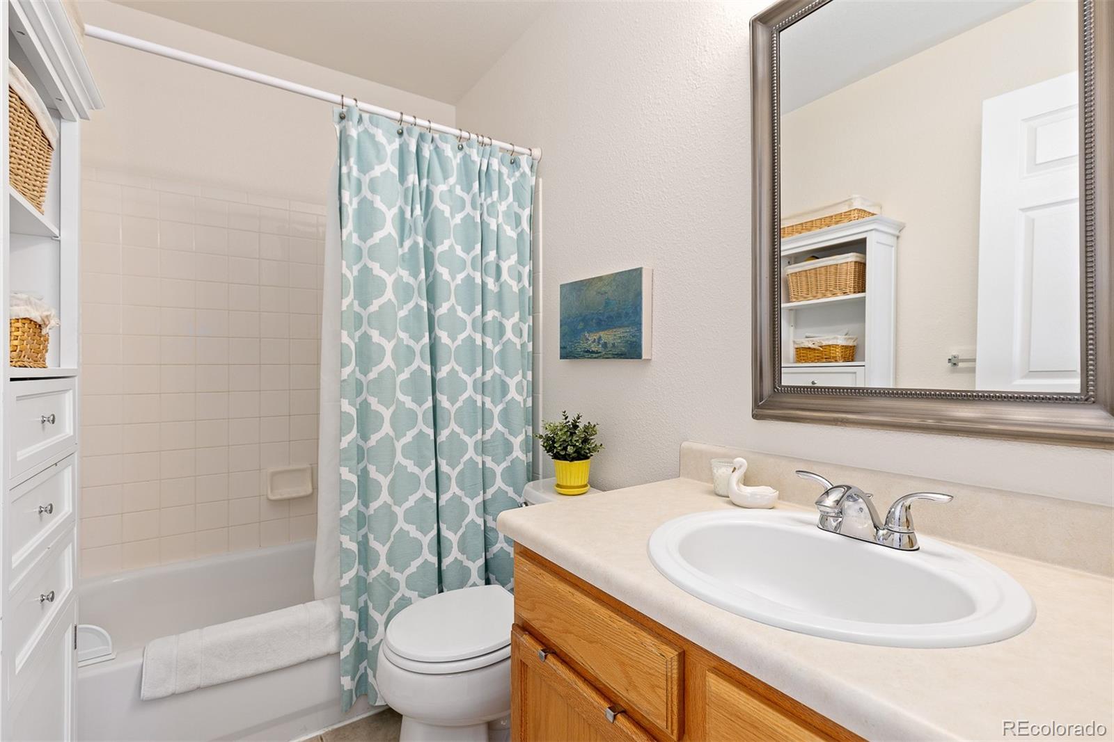 9810 Mulberry Way Highlands Ranch, CO 80129 - Photo 25 of 49 a bathroom with a sink toilet and shower