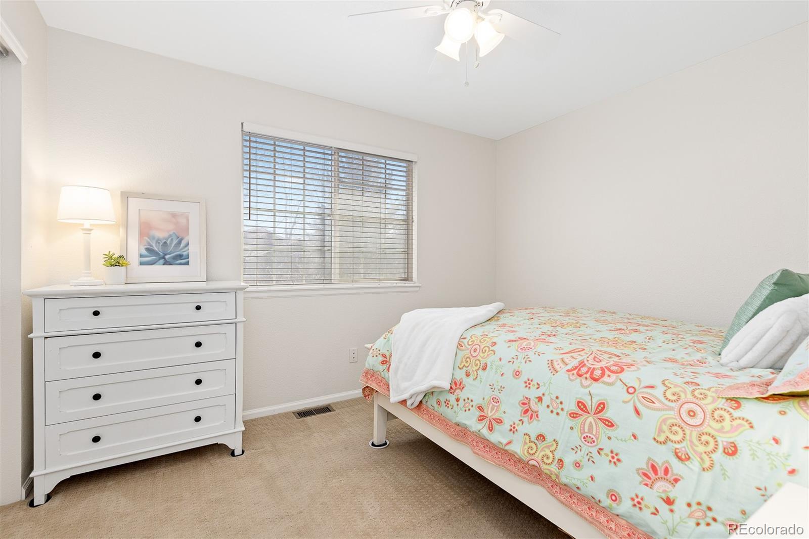 9810 Mulberry Way Highlands Ranch, CO 80129 - Photo 26 of 49 a bedroom with a bed and a dresser