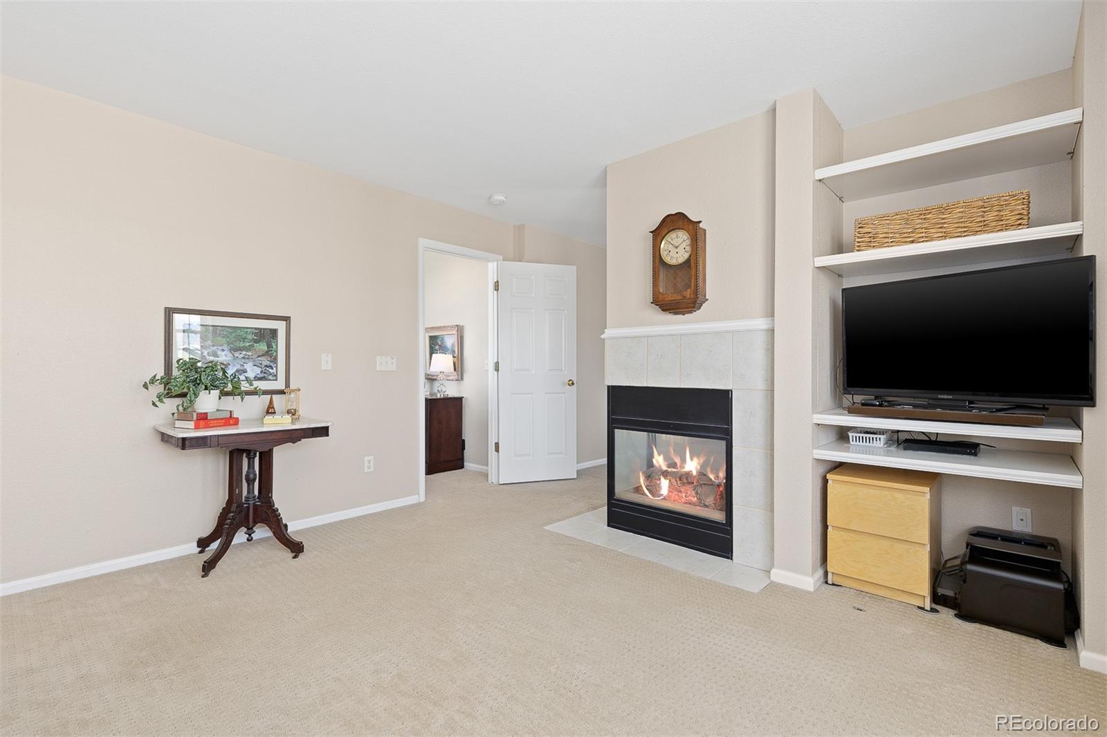 9810 Mulberry Way Highlands Ranch, CO 80129 - Photo 29 of 49 a living room with furniture a flat screen tv and a fireplace