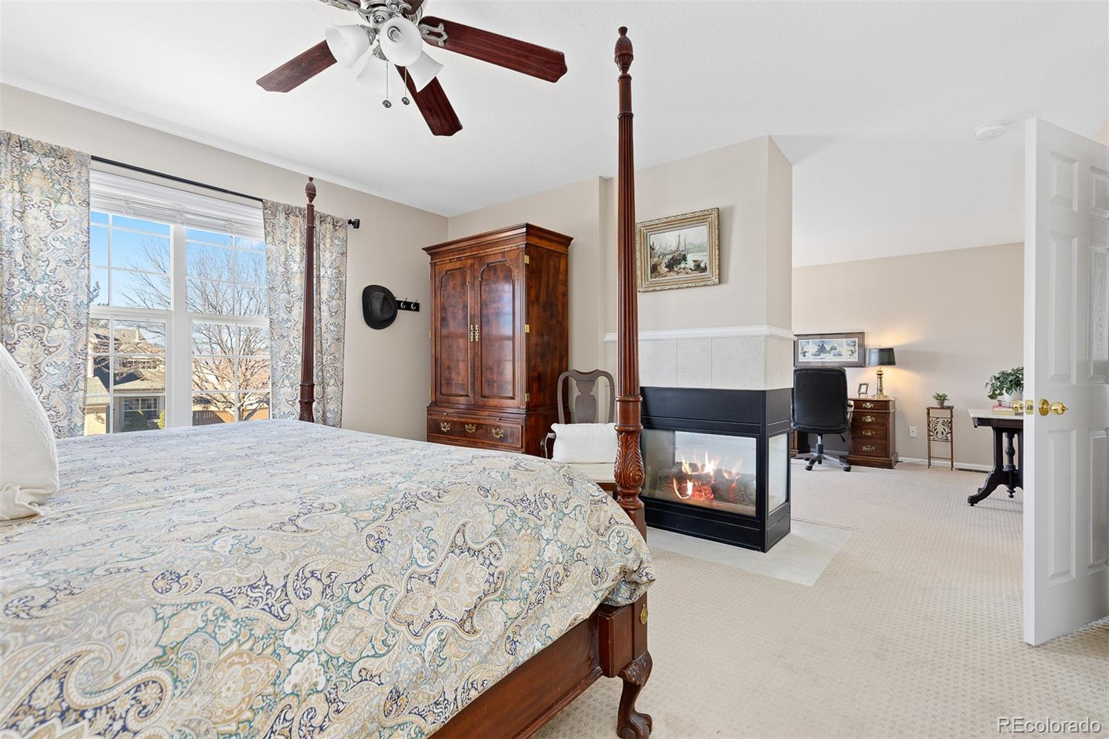 9810 Mulberry Way Highlands Ranch, CO 80129 - Photo 31 of 49 a bedroom with a bed and a chandelier