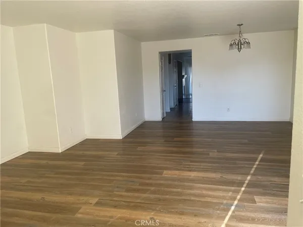 a view of an empty room and wooden floor