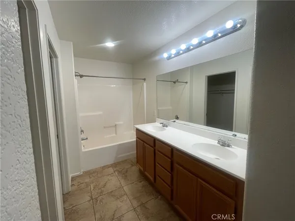 a bathroom with a bathtub sink vanity and a mirror