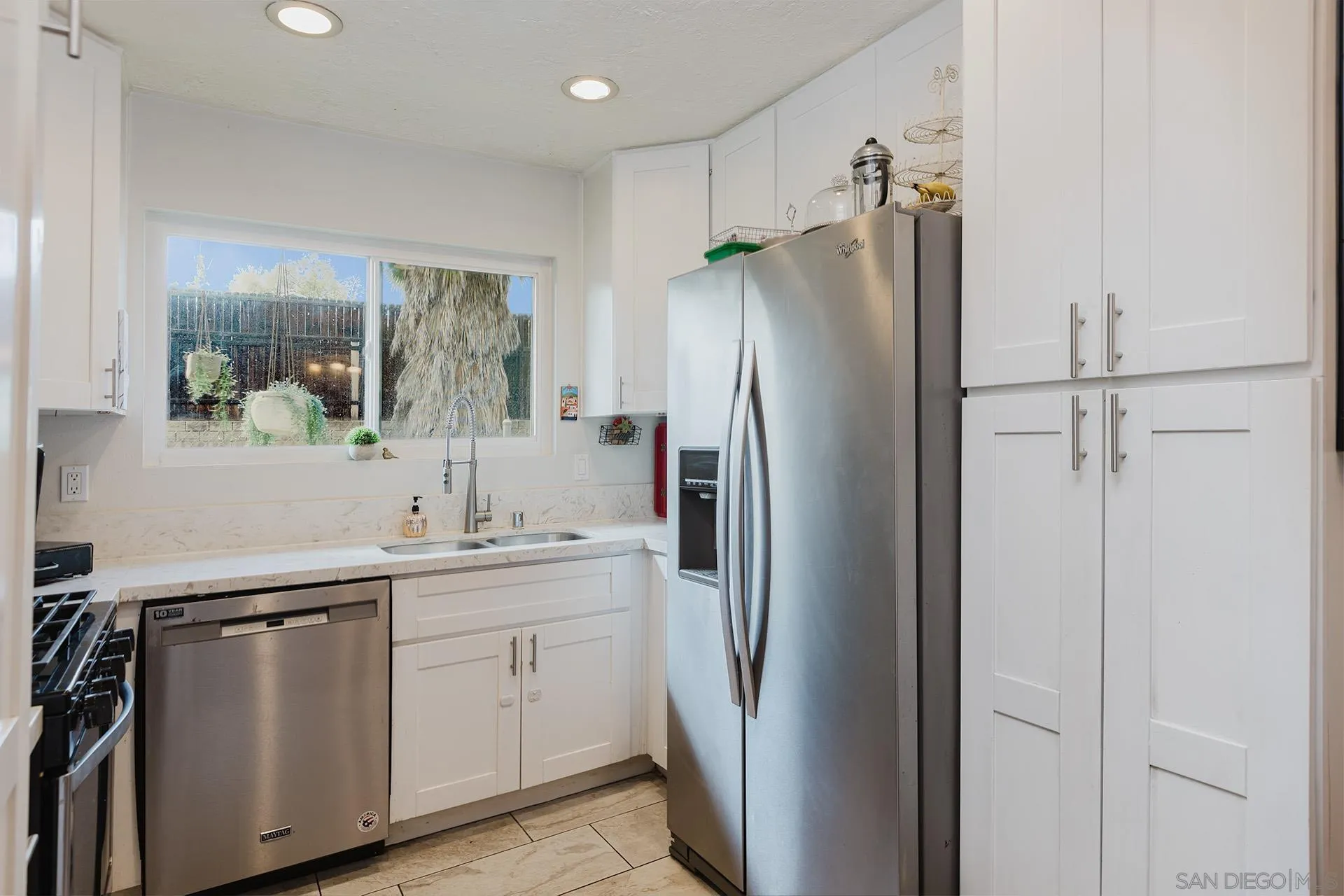 10214 Michala Place Santee, CA 92071 - Photo 11 of 25 a kitchen with stainless steel appliances a refrigerator sink and cabinets