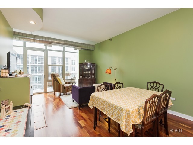 901 West Madison Street, Unit 905 Chicago, IL 60607 - Photo 3 of 10 a view of a dining room with furniture and wooden floor