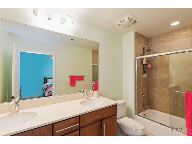 901 West Madison Street, Unit 905 Chicago, IL 60607 - Photo 7 of 10 a bathroom with a sink shower and a mirror