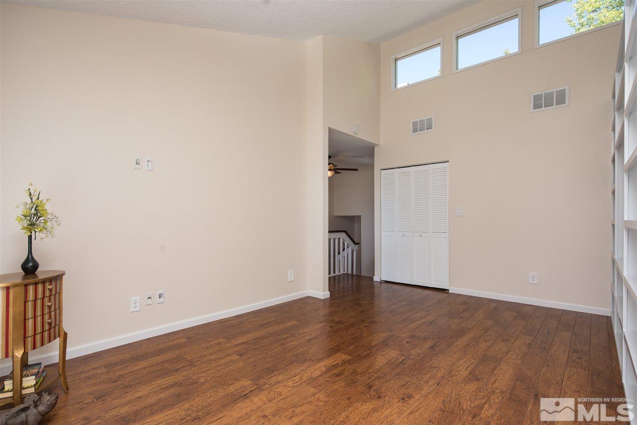 3755 Christopher Circle Reno, NV 89503 - Photo 4 of 20 a view of an empty room with wooden floor and a window