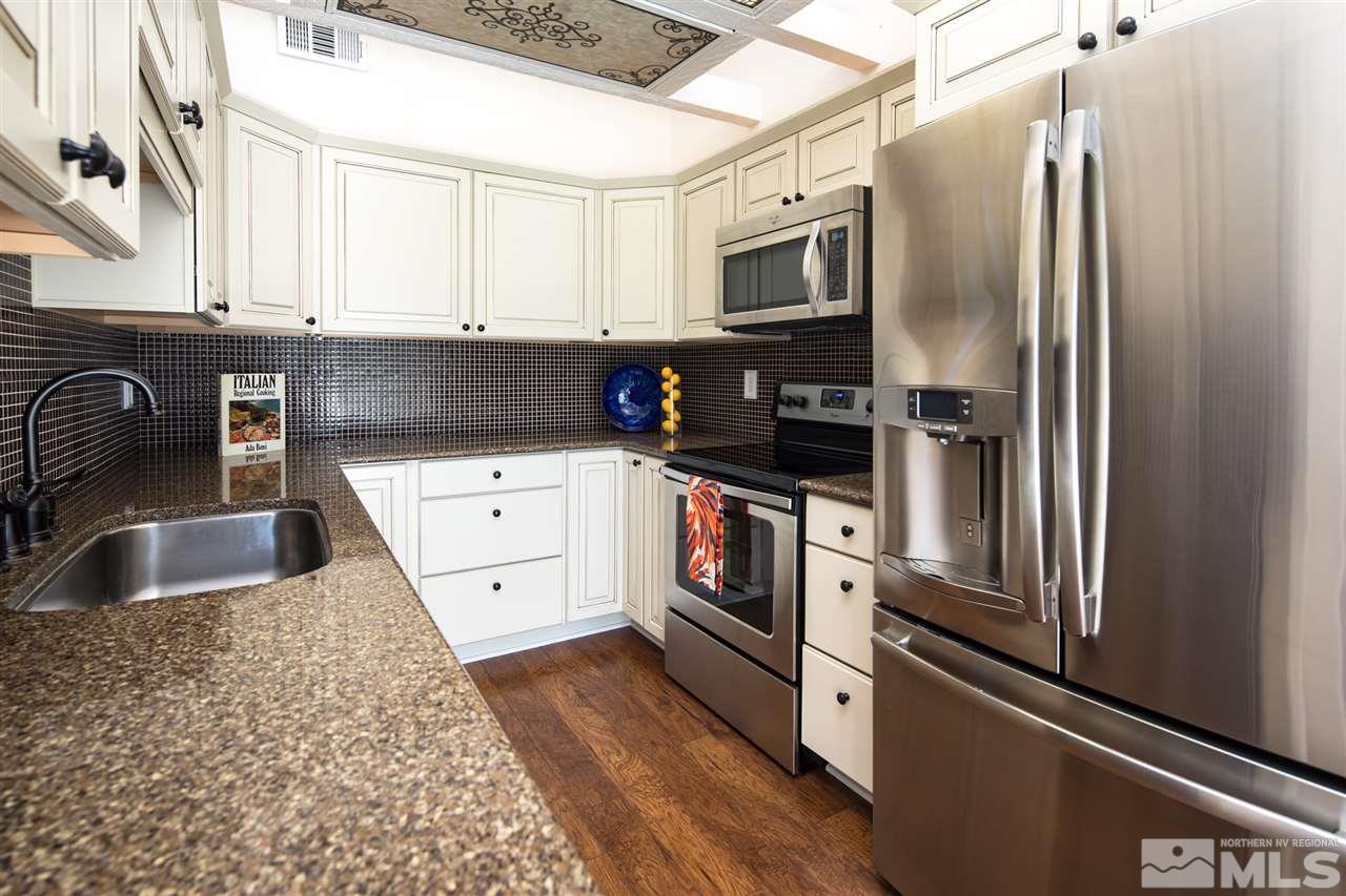 3755 Christopher Circle Reno, NV 89503 - Photo 8 of 20 a kitchen with granite countertop a refrigerator stove and sink