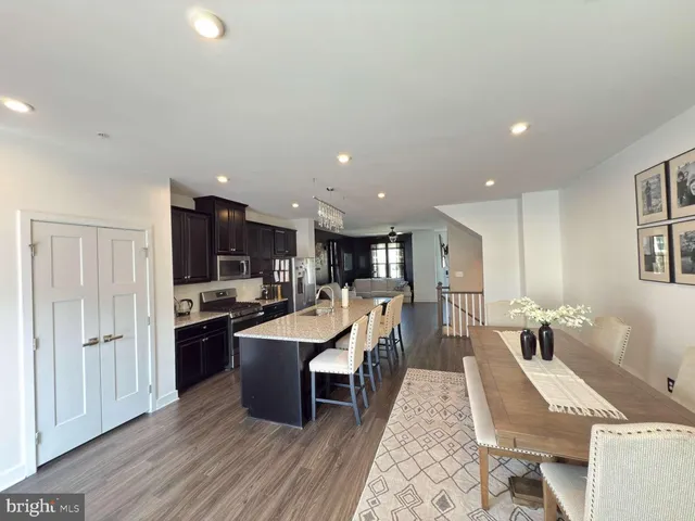 a large kitchen with a table and chairs in it