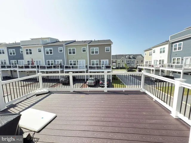a view of a roof deck with chair and wooden floor
