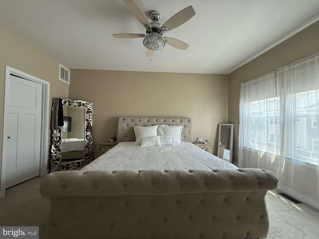 a bedroom with a bed and window