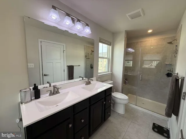 a bathroom with a sink vanity tub and a mirror