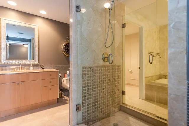 a bathroom with a shower sink and mirror