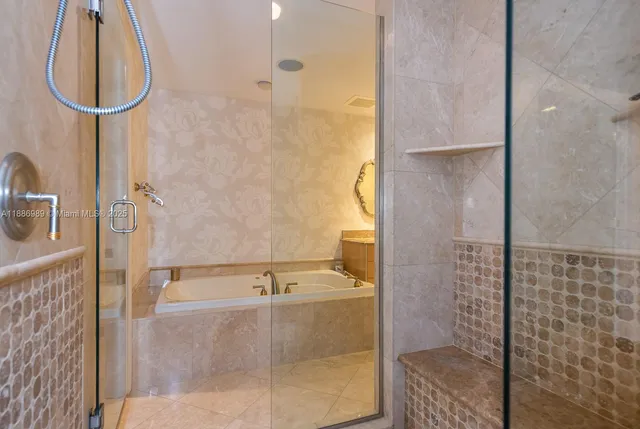 a bathroom with a bathtub and a shower