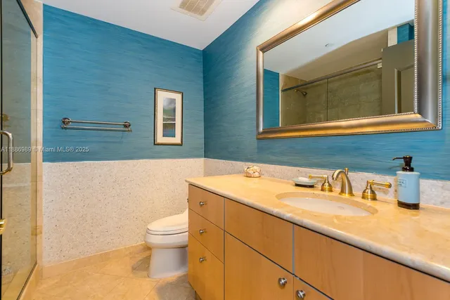 a bathroom with a toilet sink and mirror