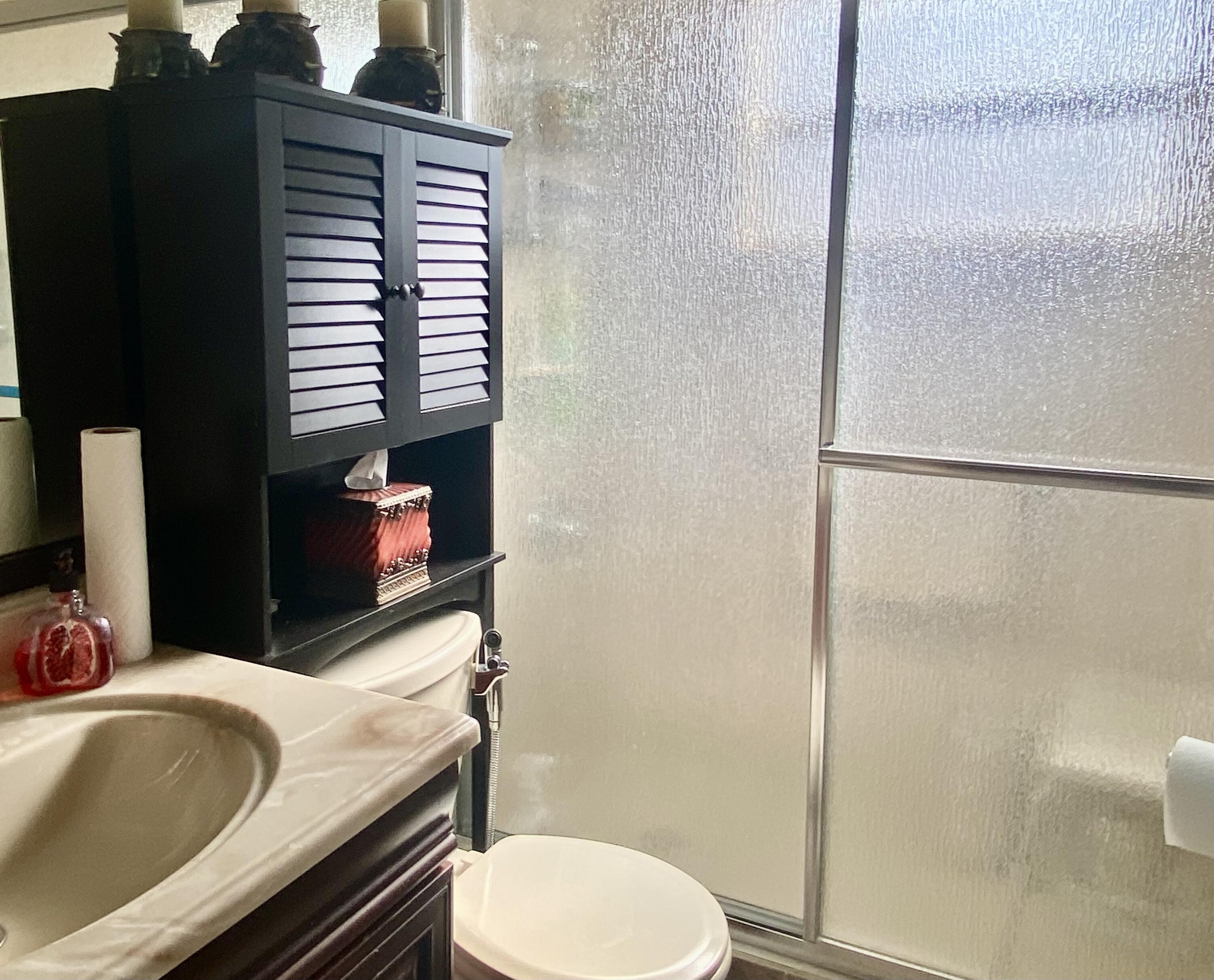 64 Flanders B, Unit 64 Delray Beach, FL 33484 - Photo 12 of 35 a bathroom with a sink and a toilet