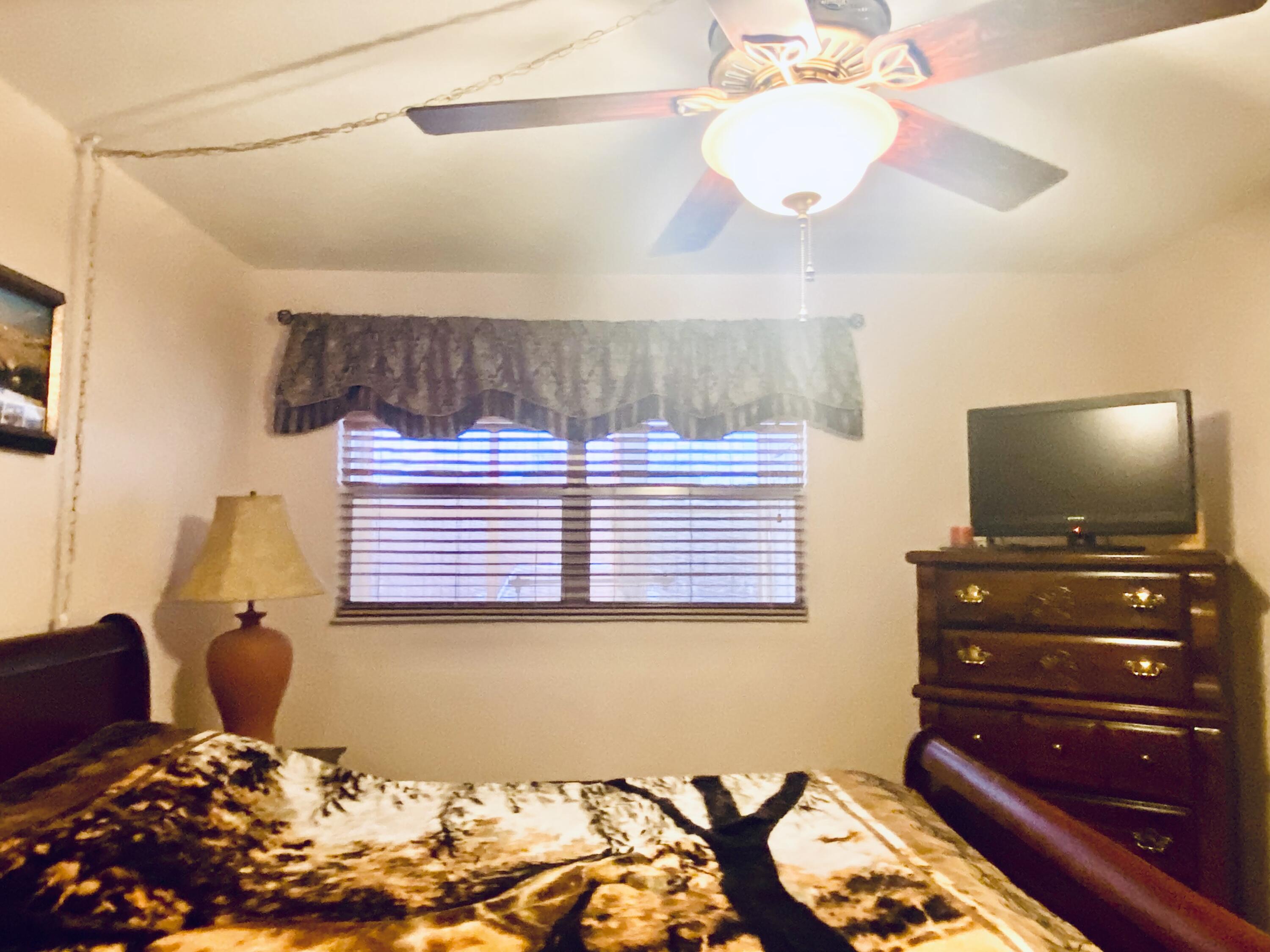 64 Flanders B, Unit 64 Delray Beach, FL 33484 - Photo 13 of 35 a bedroom with a bed and flat screen tv