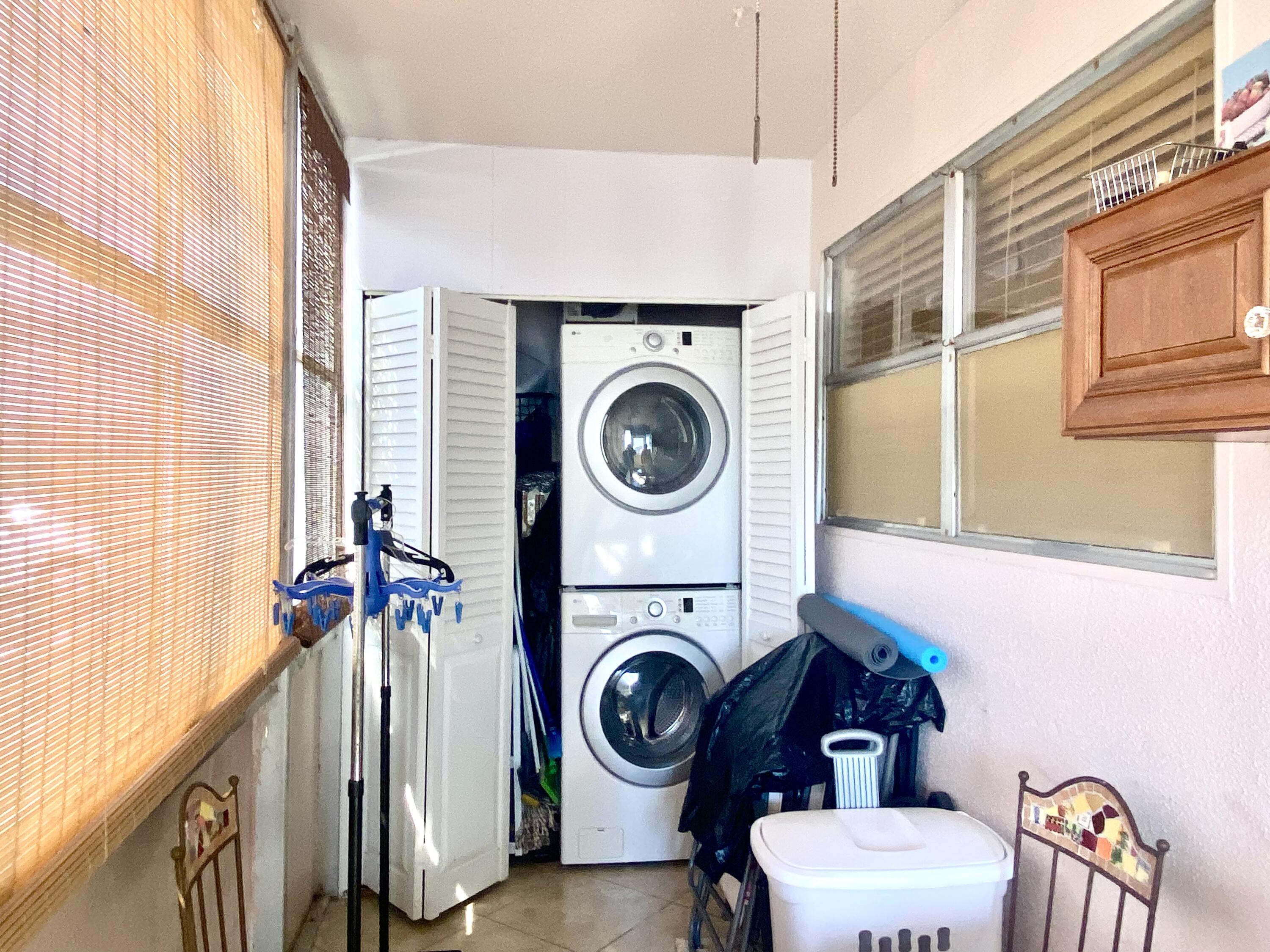 64 Flanders B, Unit 64 Delray Beach, FL 33484 - Photo 15 of 35 a view of a bedroom with washer and dryer