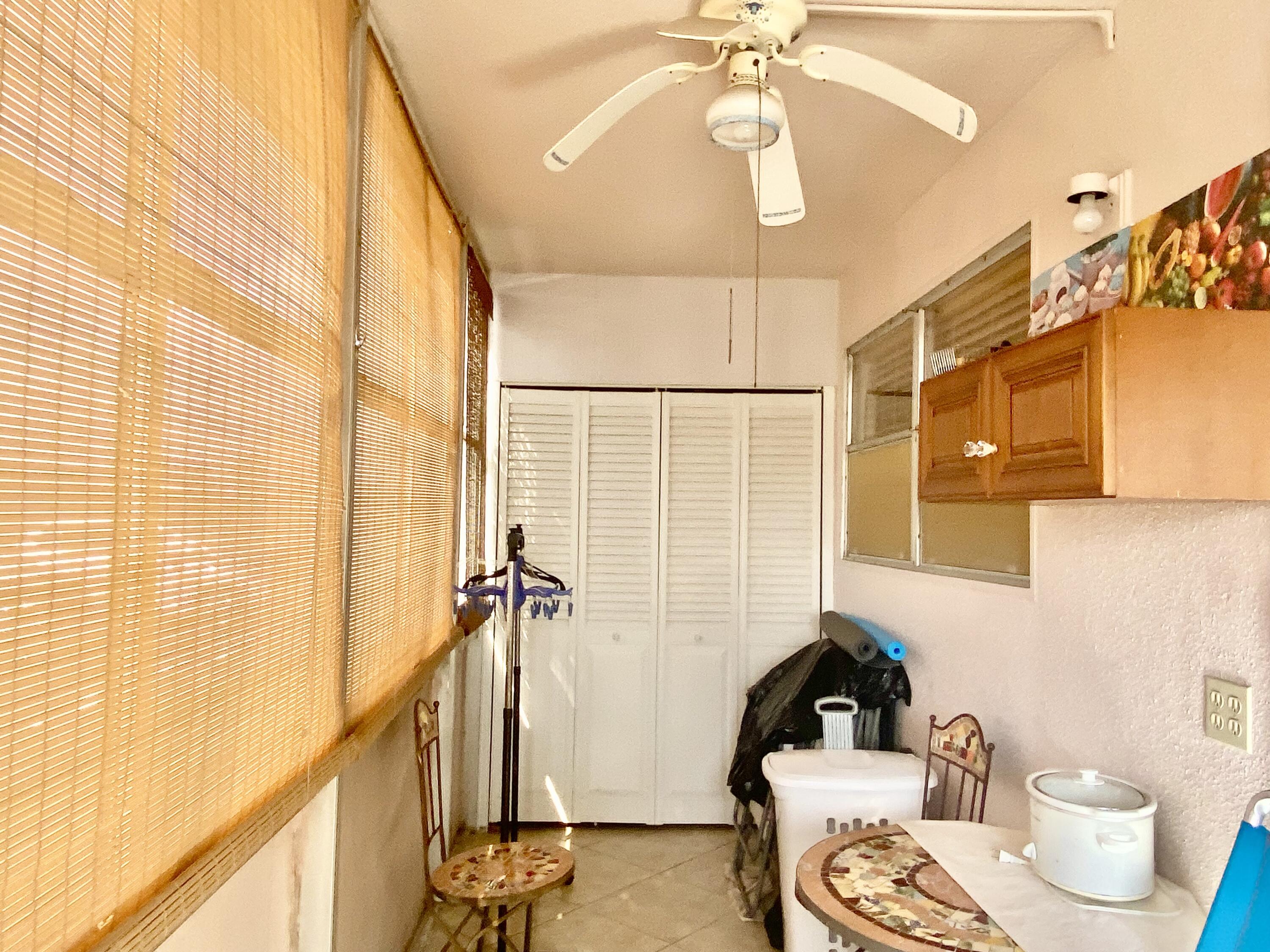 64 Flanders B, Unit 64 Delray Beach, FL 33484 - Photo 16 of 35 a bathroom with a sink a toilet and shower curtain