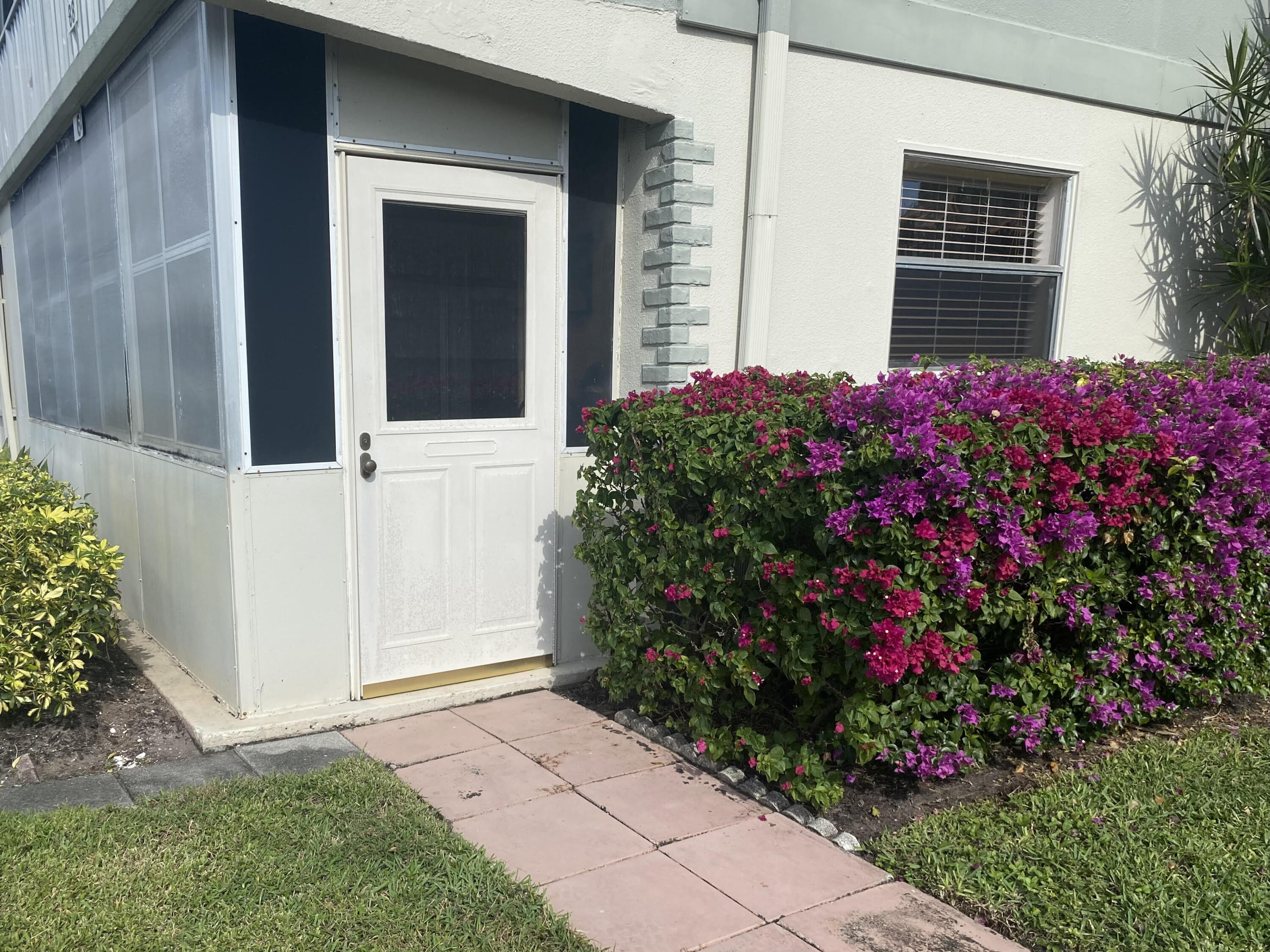 64 Flanders B, Unit 64 Delray Beach, FL 33484 - Photo 19 of 35 a view of a house with a flower garden