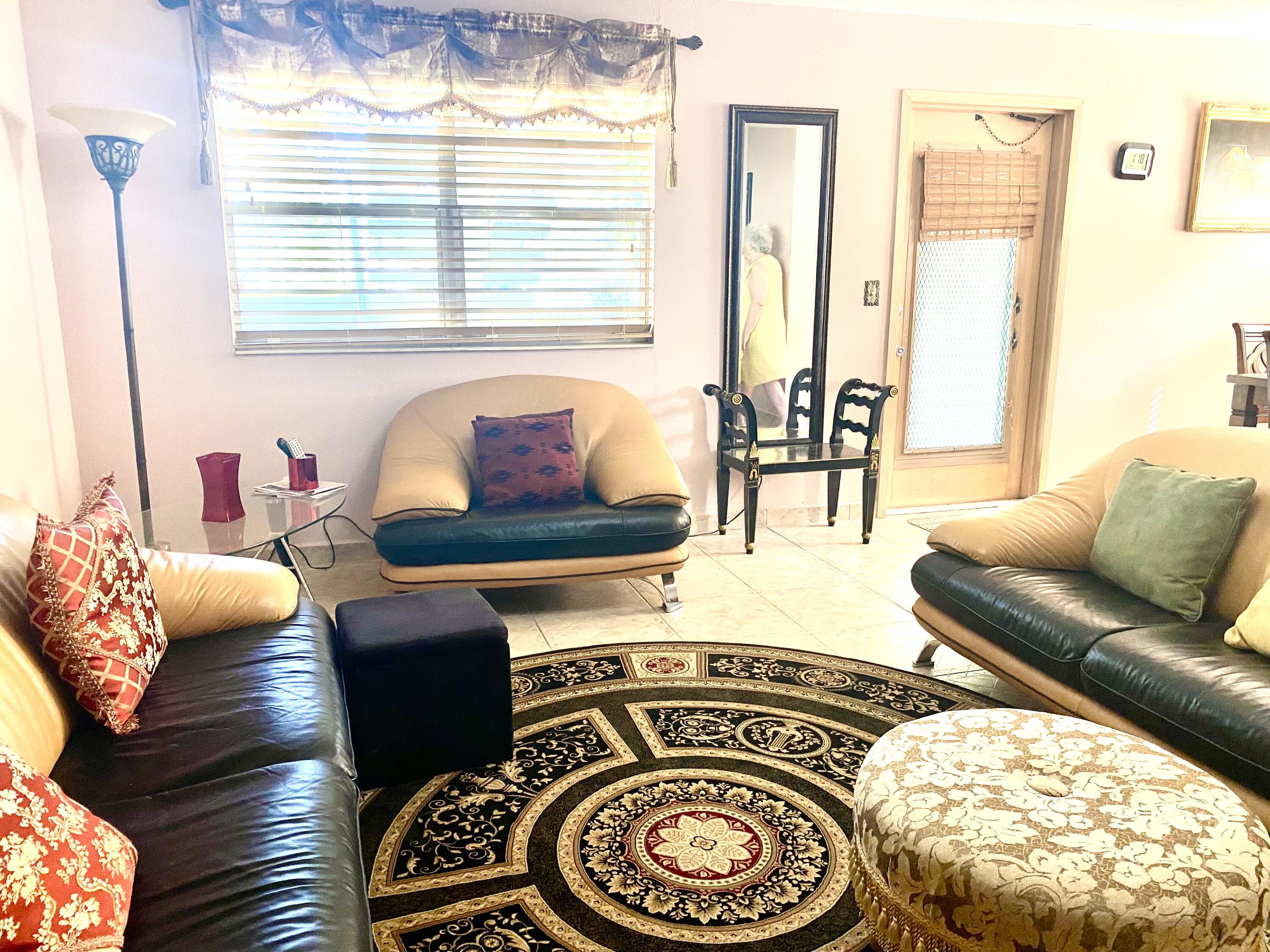 64 Flanders B, Unit 64 Delray Beach, FL 33484 - Photo 2 of 35 a living room with furniture and a large window