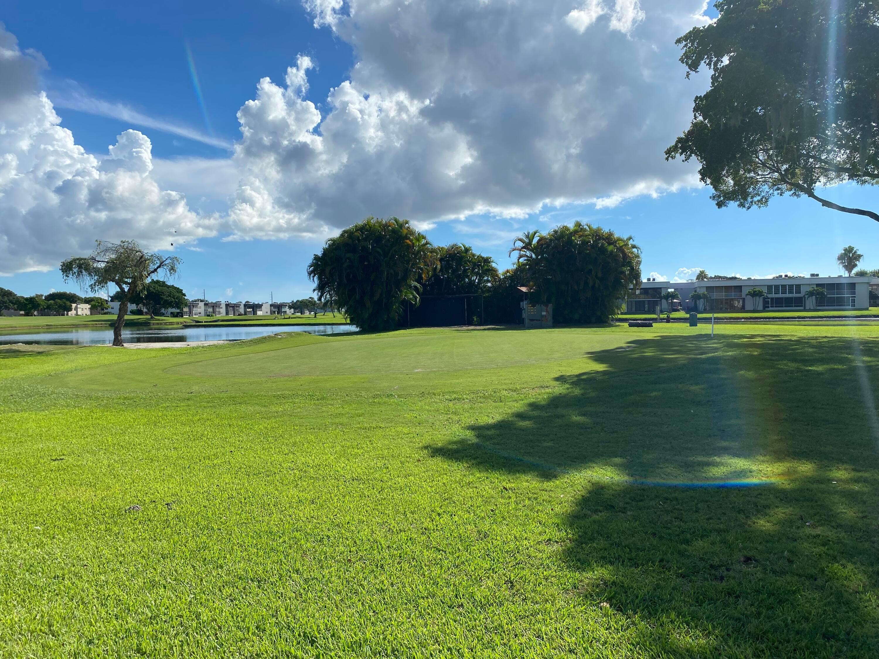 64 Flanders B, Unit 64 Delray Beach, FL 33484 - Photo 27 of 35 a view of a golf course with a lake
