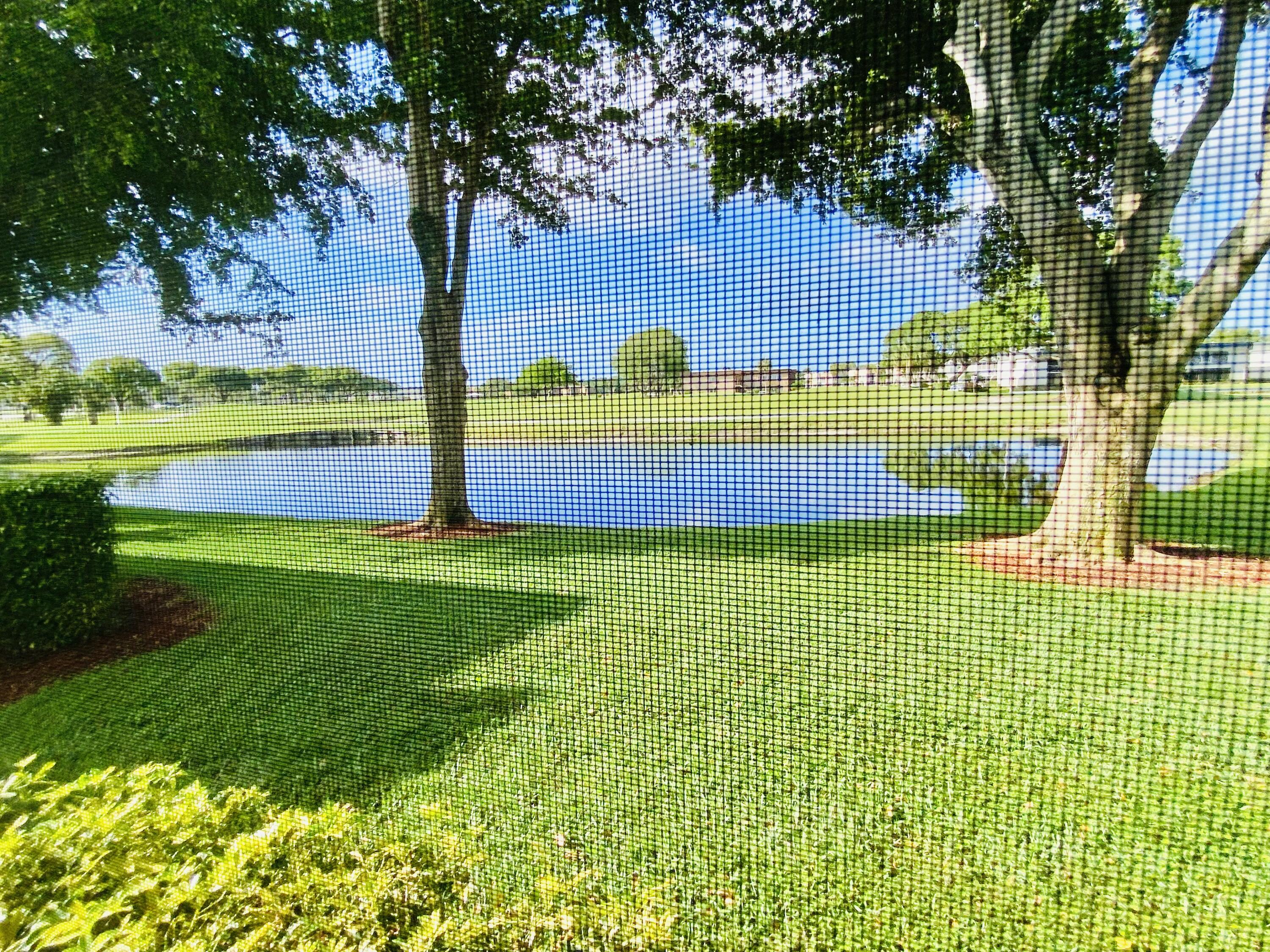 64 Flanders B, Unit 64 Delray Beach, FL 33484 - Photo 33 of 35 a view of yard with swimming pool and green space