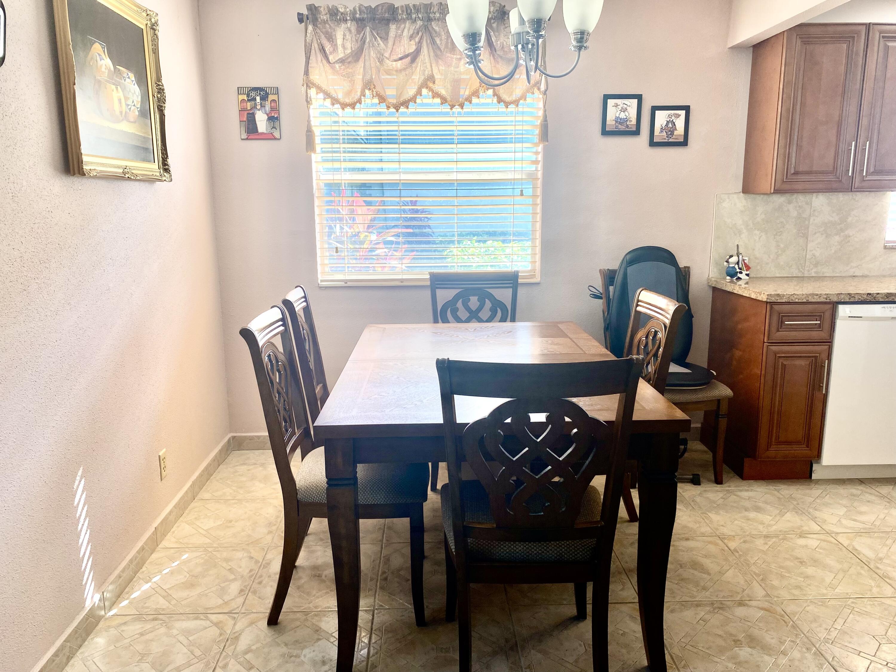 64 Flanders B, Unit 64 Delray Beach, FL 33484 - Photo 6 of 35 a view of a dining room with furniture and a window