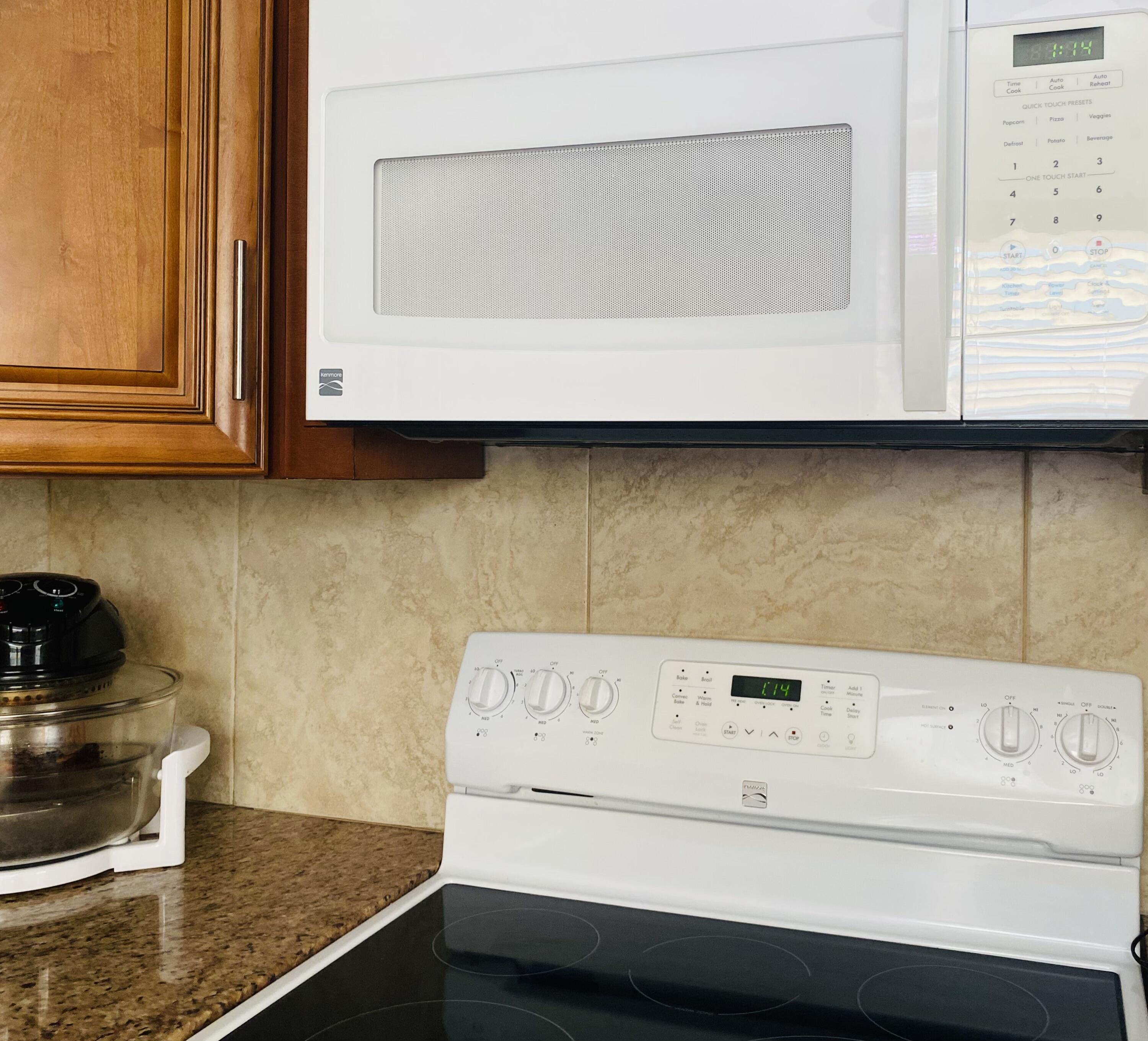 64 Flanders B, Unit 64 Delray Beach, FL 33484 - Photo 9 of 35 a kitchen with a stove and a microwave
