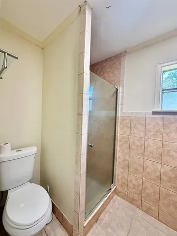 a bathroom with a shower and toilet