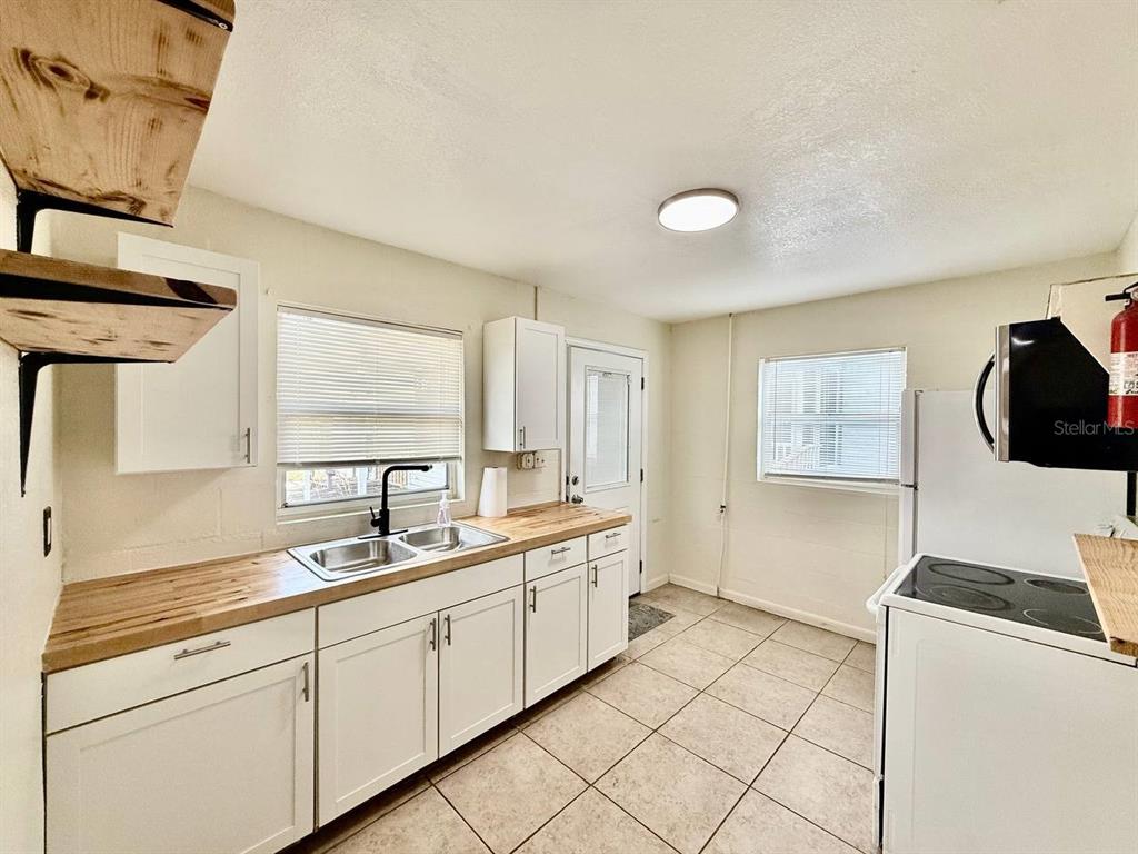 804 East 127th Avenue, Unit B Tampa, FL 33612 - Photo 5 of 16 a spacious bathroom with a double vanity sink mirror and