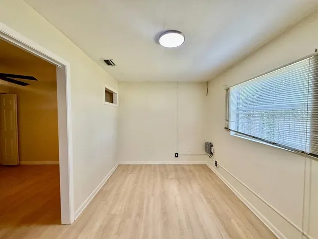 a view of room with window and hardwood floor