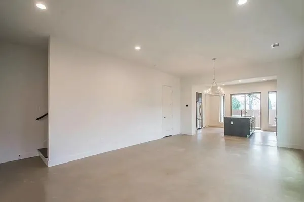 an empty room with fireplace and windows