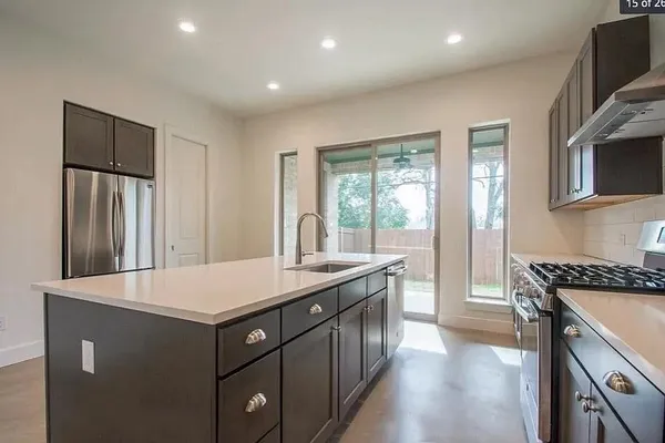 a kitchen with a sink appliances and cabinets