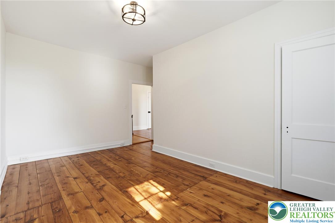 4682 Steuben Road Bethlehem, PA 18020 - Photo 30 of 79 Natural light illuminates the rich hardwood flooring in this spacious, unfurnished room.