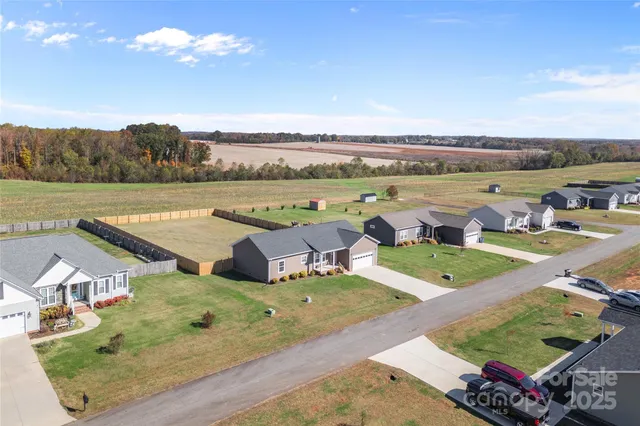 an aerial view of a house with outdoor space patio and lake view
