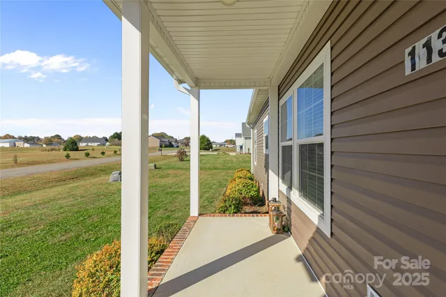a view of a glass door and a yard from a balcony