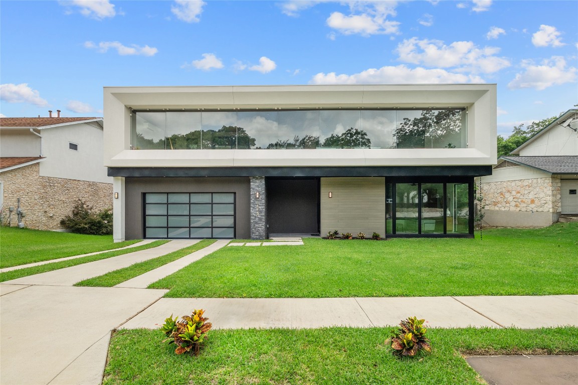 a view of a swimming pool with a yard and plants