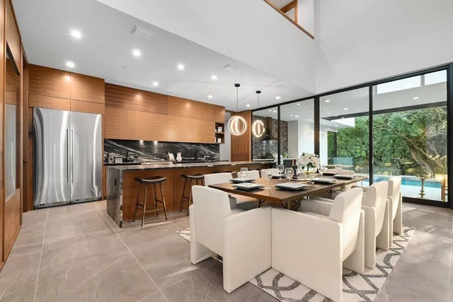 a kitchen with stainless steel appliances kitchen island granite countertop a sink and cabinets