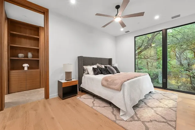 a bedroom with a large bed and a large window