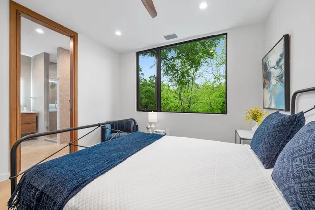 a bedroom with a large bed and a large window