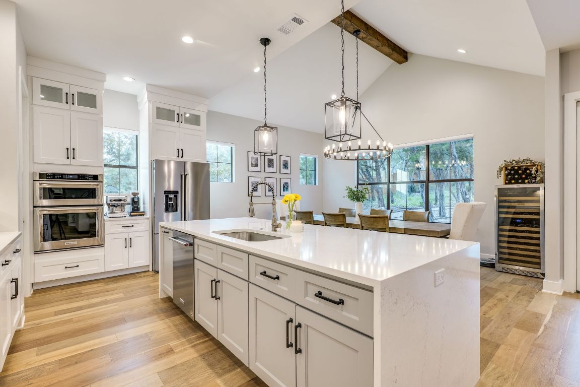 5904 Hudson Bend Road Austin, TX 78734 - Photo 12 of 37 The stunning kitchen features an oversized island with quartz waterfall edge that sets the tone.