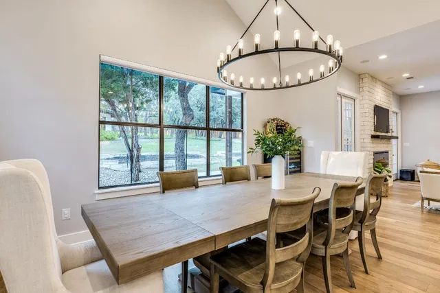 a bathroom with a double vanity sink and mirror with window