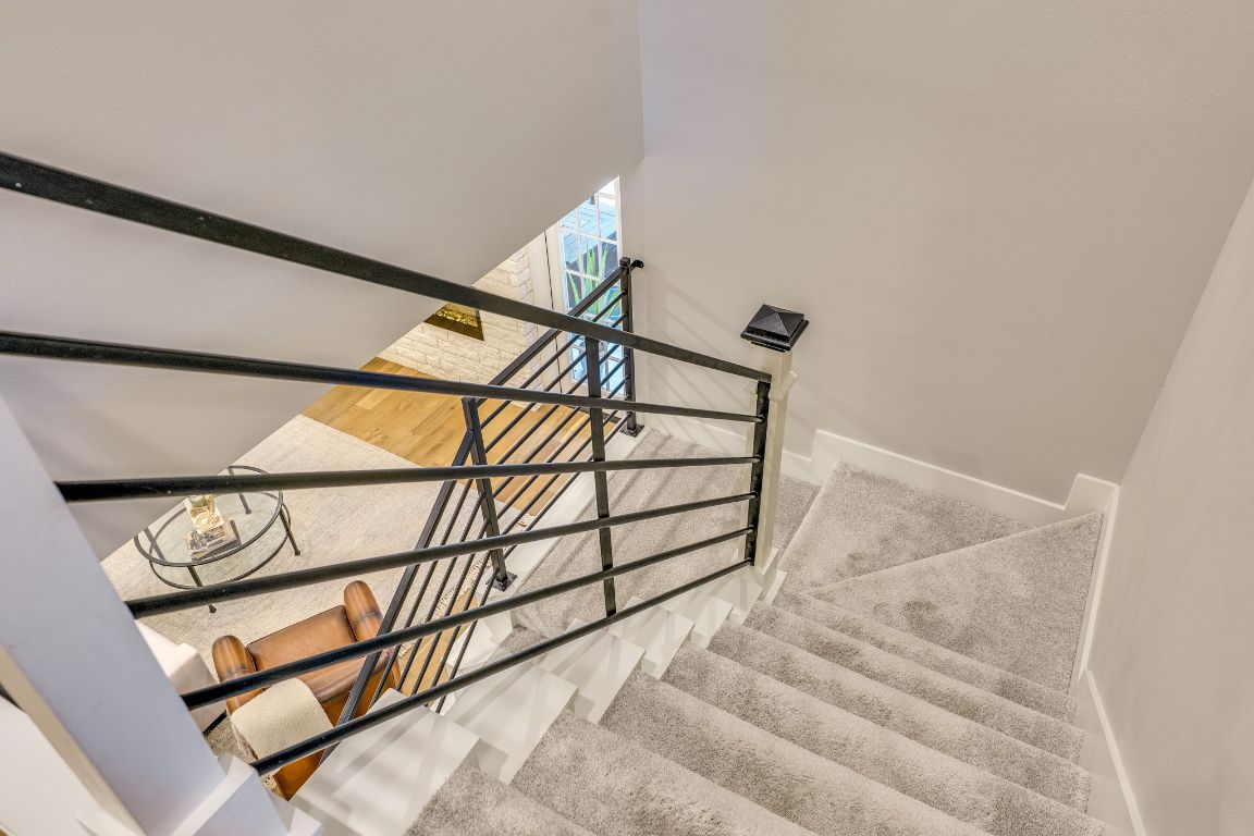 5904 Hudson Bend Road Austin, TX 78734 - Photo 25 of 37 The stairwell features sleek iron horizontal railings that add a modern and sophisticated touch to the space.