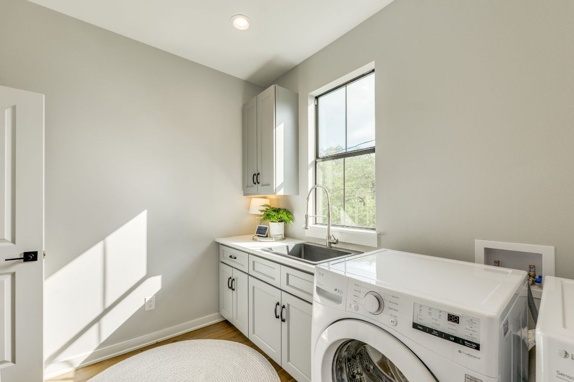 5904 Hudson Bend Road Austin, TX 78734 - Photo 29 of 37 There are TWO laundry areas in this house. This second level laundry room features a folding station with sink and closet for storage.