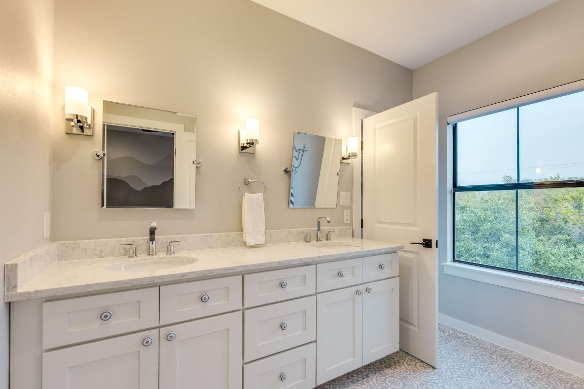 5904 Hudson Bend Road Austin, TX 78734 - Photo 31 of 37 A Jack and Jill bathroom separates the two bedrooms, featuring dual vanities. It's perfect for siblings to have their own space.